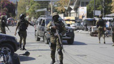 US flies forces in to beef up security at embassy in Haiti and evacuate nonessential personnel