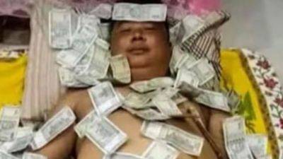Action - Assam politician Benjamin Basumatary seen sleeping on bed of ₹500 notes, viral photo prompts backlash - livemint.com