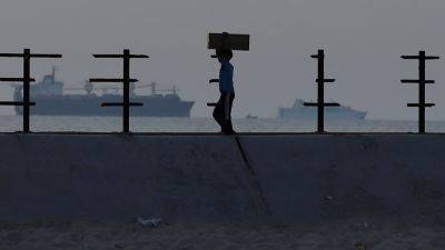 More aid getting from US pier to people in Gaza, officials say, after troubled launch
