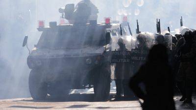 Troops and armored vehicles disperse as Bolivia arrests army chief leading coup attempt