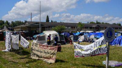 Hundreds of asylum-seekers are camped out near Seattle. There’s a vacant motel next door