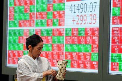 Xi Jinping - Associated Press - Stock market today: Asian stocks are mixed after Dow sets a new record - independent.co.uk - China - city Beijing - Australia - Japan - South Korea - Hong Kong - city Shanghai