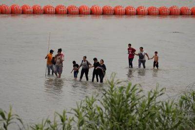 Greg Abbott - Via AP news wire - Texas' floating Rio Grande barrier can stay for now, court rules as larger legal battle persists - independent.co.uk - state Texas - Mexico - county Rio Grande