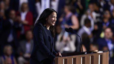 Joe Biden - Kamala Harris - Trump - Bernie Sander - Tim Walz - C Mandler - AOC speaks to the middle class in her first major convention appearance - npr.org - city New York - Israel - New York - city Chicago - state Vermont - city Sander