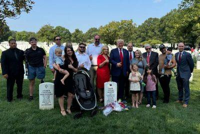 Adam Kinzinger - Gustaf Kilander - Tulsi Gabbard - Spencer Cox - Trump slammed for flashing smile and making ‘disgraceful’ thumbs up at soldiers’ graves - independent.co.uk - Usa - Afghanistan - state Virginia - state Michigan - state Utah - state Hawaii - city Detroit, state Michigan - city Kabul - county Arlington