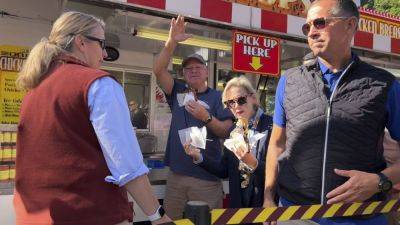 It’s a pork chop on a stick and a vanilla shake for Tim Walz at the Minnesota State Fair